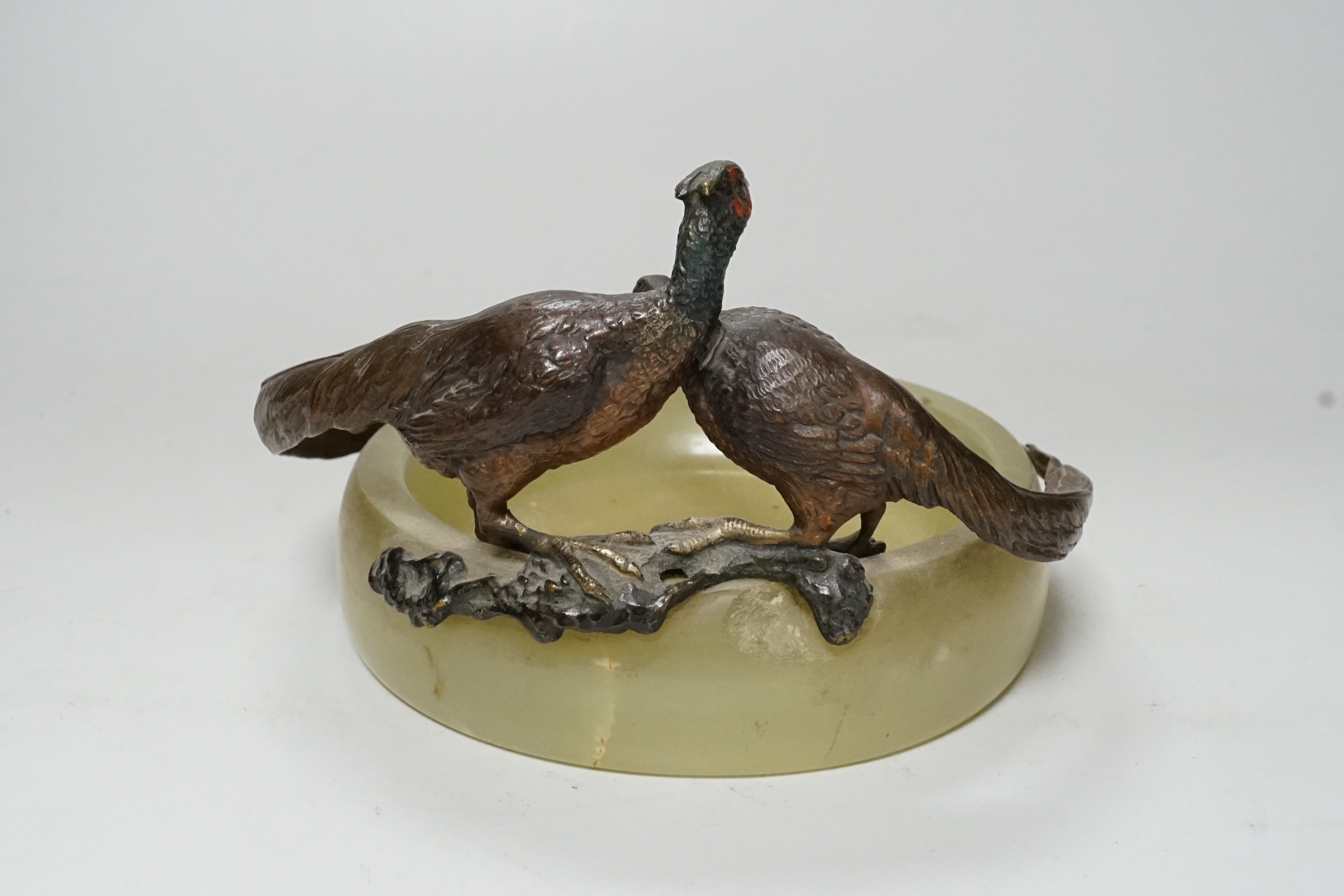 A cold painted bronze ‘pheasant’ mounted onyx ashtray, 17cm wide